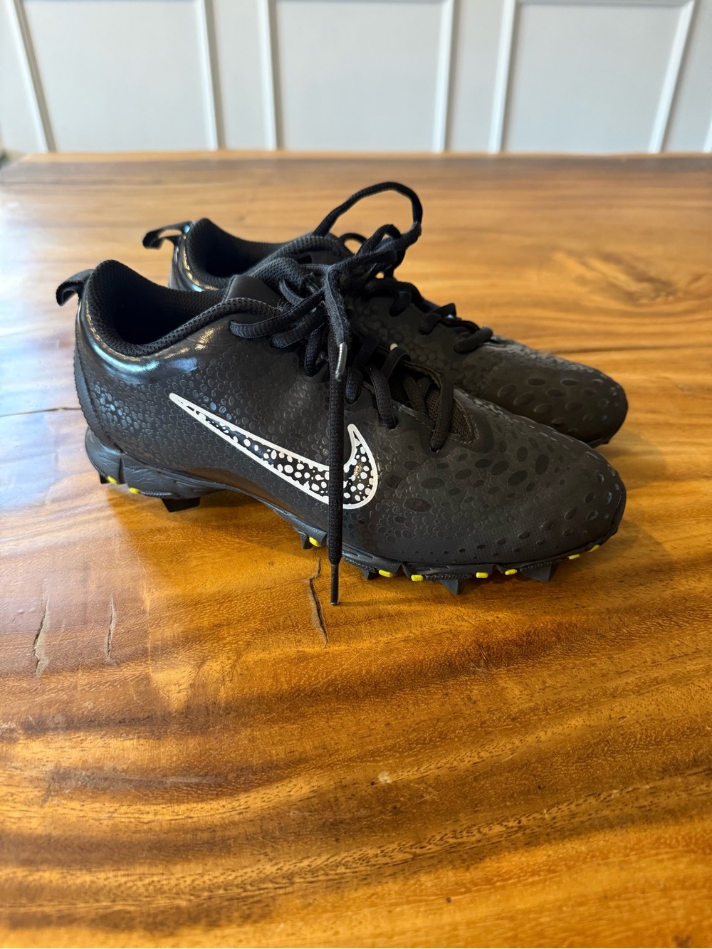 Nike Black Soccer Cleats with White Swoosh and Yellow Stud Accents